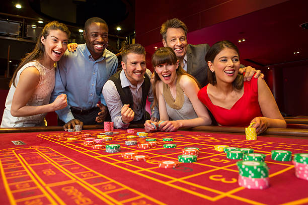 Group Of Friends Playing Roulette In Casino